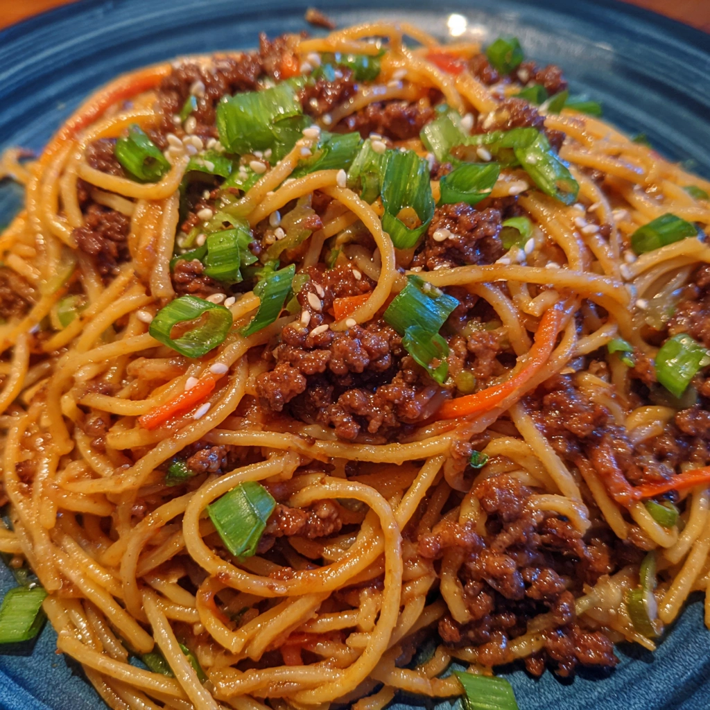 Ground beef and noodles tossed in glossy sauce